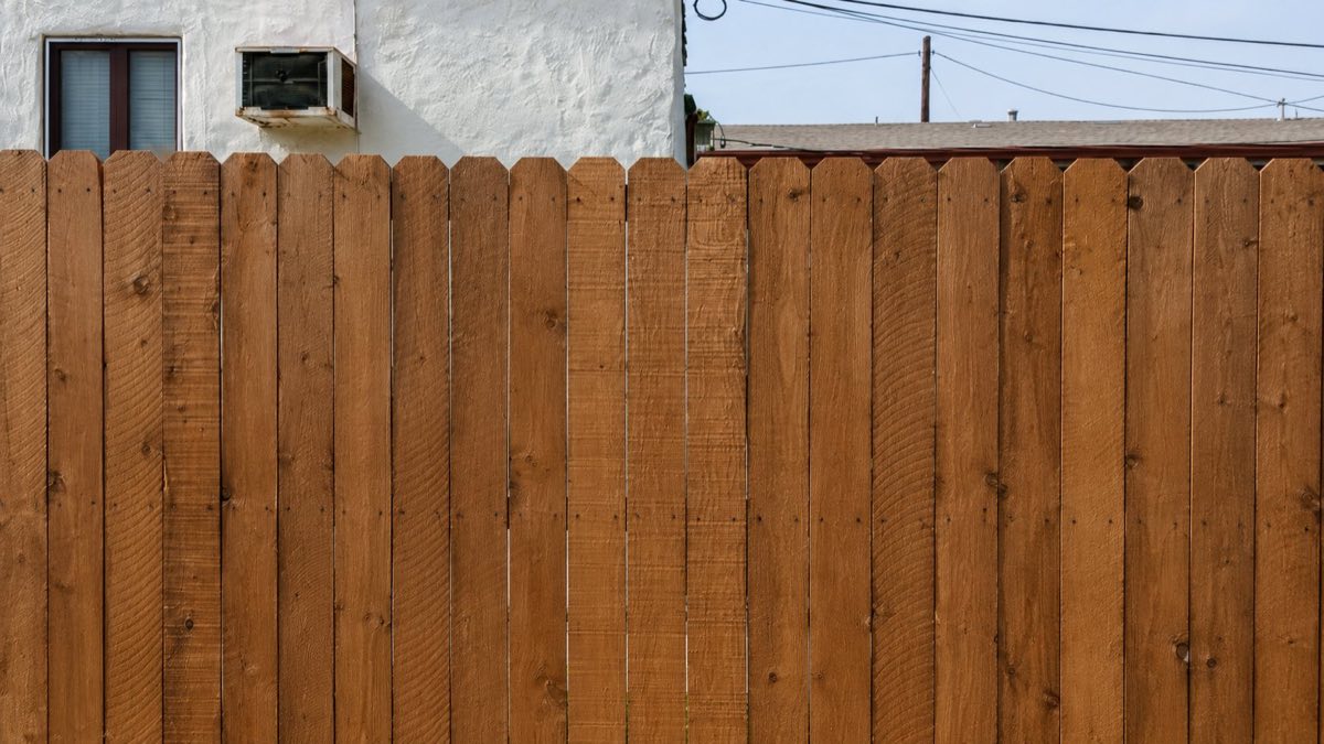 Cedar privacy fence repainted in natural finish