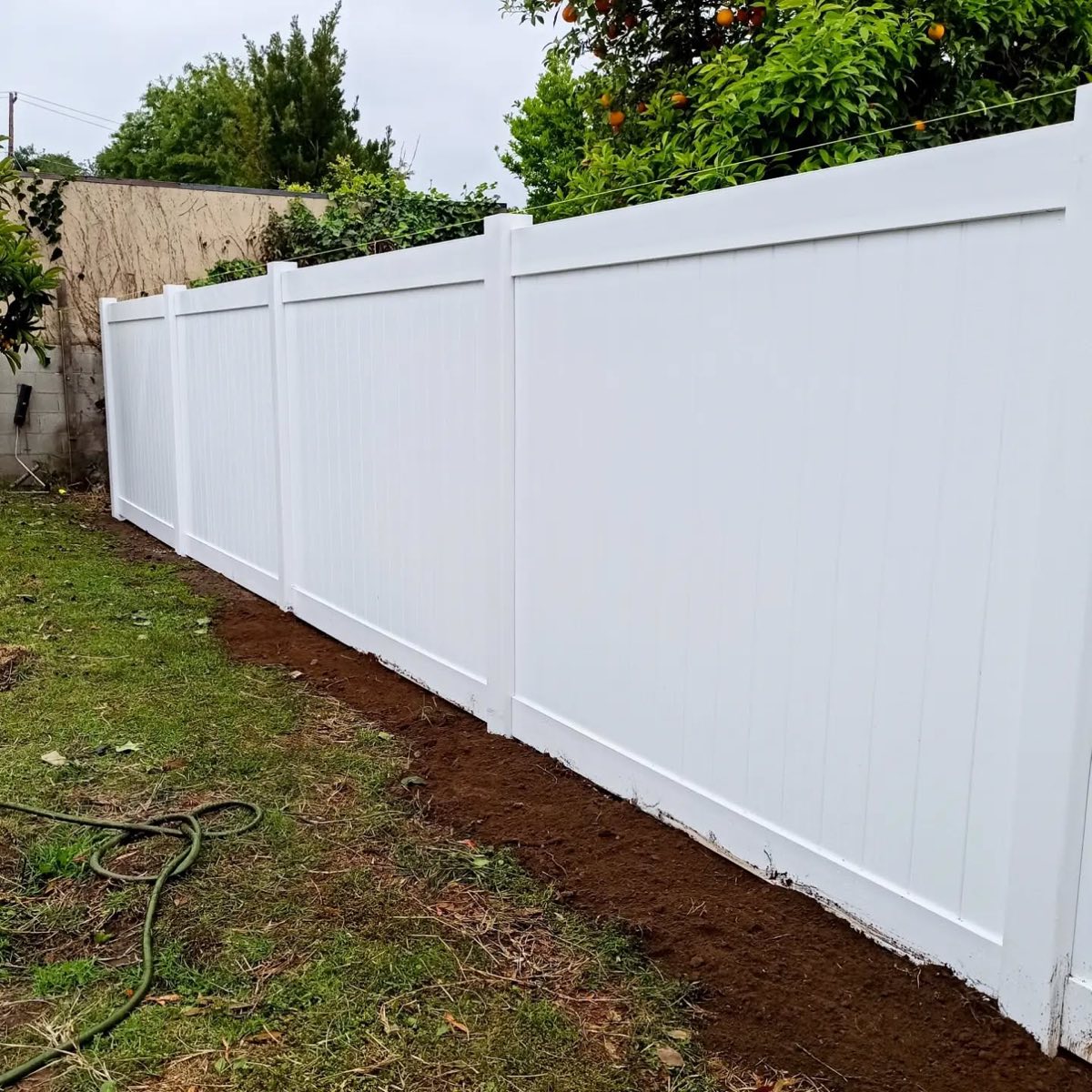 Refreshed wood fence backyard angle