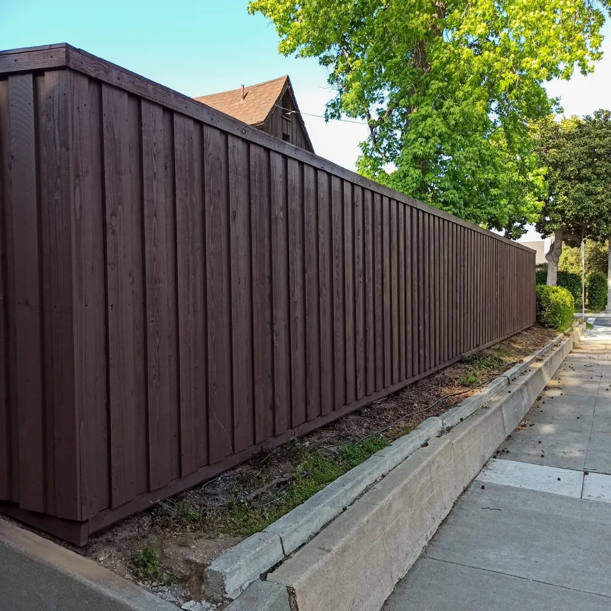 Wood fence wrapping yard corner