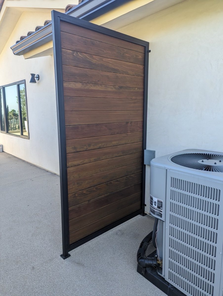 Wood fence by driveway, before stain